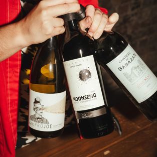 WINE BOTTLES IN HAND FROM GASCONY